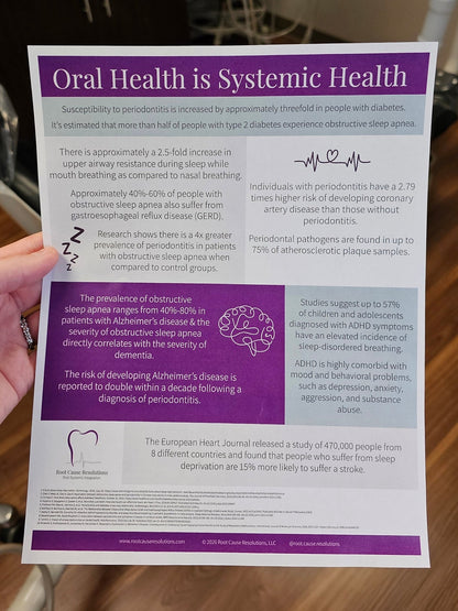 Clinical photo- sheet of paper with text on oral health, sleep apnea, and oral-systemic connections featuring a purple border and tooth outline with EKG line at the bottom, the Root Cause Resolutions LLC logo